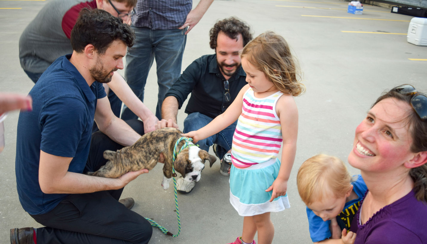 Chad Garven, Liam Cummings, Erin Nash and children with bulldog puppy -