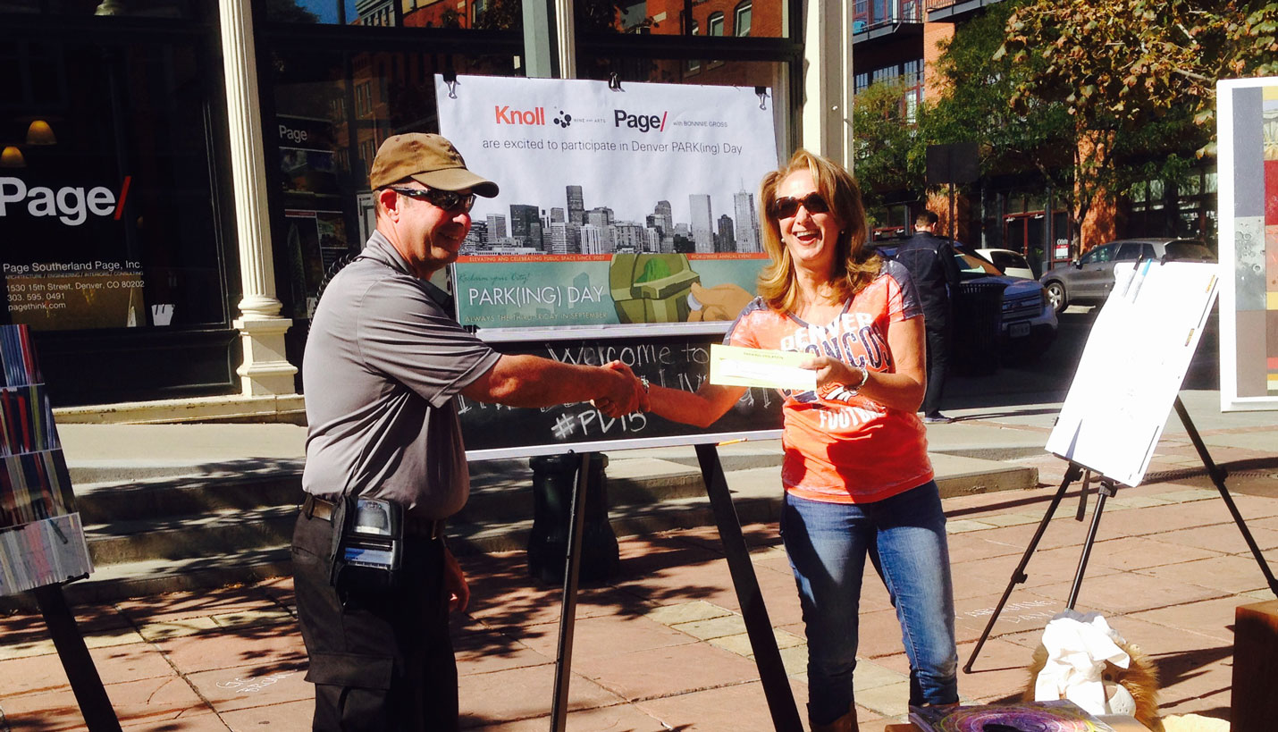 Page Principal Mary Morissette shakes hands with the parking enforcement officer during Denver Parking Day 2015 -