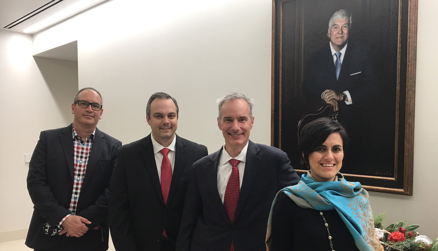 Representative members of the Page project team stand in front of a portrait of Wayne A. Reaud, for whom Lamar University's new academic building is named, at the recent dedication ceremony. (L-R): Luis Reyes, Justin Winchester, Aaron Jones and Yvette Herrera Durán. -