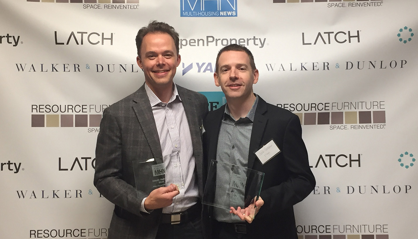 Page Principals Talmadge Smith, left, and Josh Coleman accepted MHN Excellence Awards on behalf of their respective project teams for Fountain Place and 70 Rainey. -