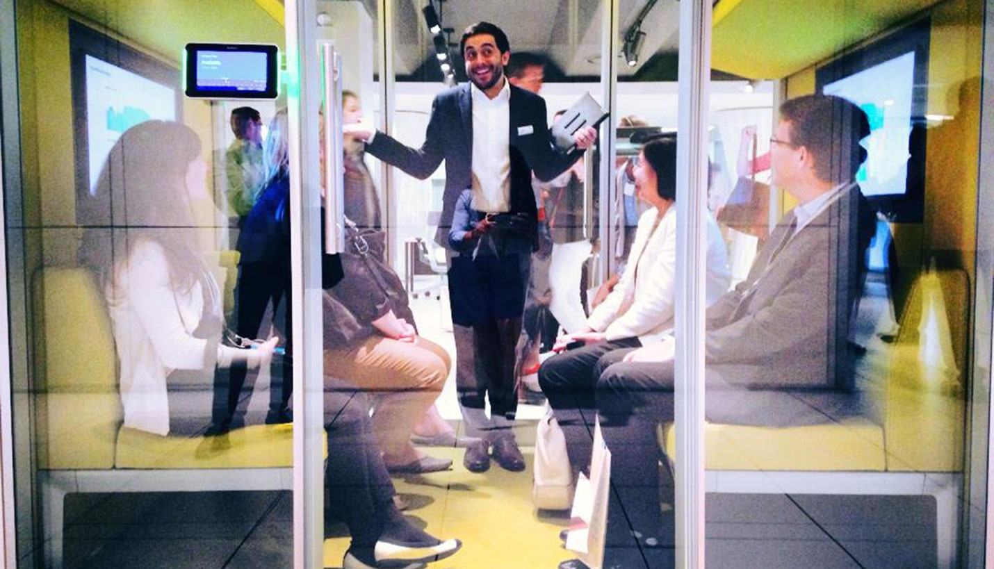 Page Interiors team members attend a display inside a Steelcase demonstration meeting space. -